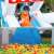 Kids playing in Pepita Shark XL inflatable bounce house with slide and pool