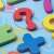 Close-up of wooden number puzzle pieces for babies, colorful educational toy