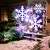 Snowflake LED projector in use, projecting snowflakes on house wall