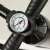 Close-up of the pressure gauge on the AquaPaddle manual air pump, showing PSI and bar units