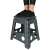 Person standing on dark gray foldable step stool with non-slip surface