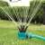360 degree rotating sprinkler with adjustable nozzles spraying water on the lawn