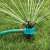 360 degree rotating sprinkler with adjustable nozzles spraying water on the lawn