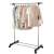 Springos telescopic clothes rack with wheels, silver and black, in use, with clothes hanging on it