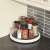 White rotating spice rack with various spices and bottles on a kitchen counter