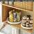 Rotating storage tray in use, storing spices in a kitchen cabinet