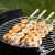 Barbecook BC-ACC-7068: Shrimp skewers grilling on a BBQ