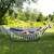 Woman relaxing in a Springos double hammock with a stand, in a garden setting