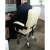 Person sitting in the beige ergonomic office chair with footrest, Malatec