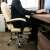Person sitting in the beige ergonomic office chair with footrest, Malatec