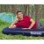 Man relaxing on Bestway inflatable camping mattress outdoors