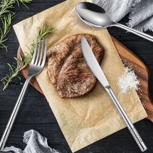 TRENDY’S luxury stainless steel cutlery set, 24 pieces, for 6 people, showing a fork, knife, and spoon on a wooden board with a steak - Serving