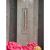 Plexiglass thermometer mounted on a wooden fence with flowers in the foreground.