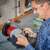 Man sharpening scissors on Einhell TC-WD 200/150 wet and dry grinding machine