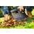 Person using Cellfast IDEAL PRO 525mm Leaf Rake to gather leaves