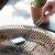 Barbecook BC-ACC-7027 grill cleaning brush in use, cleaning a grill grate