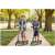 Two children riding Ricokids Kodi urban scooters, one grey and green, one orange, in a park