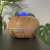 Ruhhy aroma diffuser with remote control and 3 essential oils, brown woodgrain finish, close-up of the diffuser