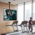 Techly ceiling TV mount in a gym setting with people exercising