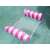 Pink and white striped inflatable pool float with mesh hammock floating in a pool