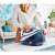 Woman using Tefal GV9221E0 steam station to iron clothes