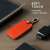 Kwmobile orange leather key cover for Renault car key with 4 buttons, showing the key cover on a table with a pen, watch, and phone