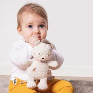 Baby holding Sleepy Bear Musical Plush Toy, close-up - Stroller & Crib Toy