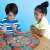 Two children playing Cauldron Quest board game, cooperative game for kids, work your magic, break the spell