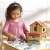 Child playing with Noah's Ark wooden playset, great for developing fine motor skills and creativity