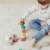 Child playing with Miniland Towering Wood Stones educational toy, stacking blocks, geometric shapes, wooden blocks, motor skills development, preschool toys