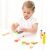 Girl playing with New Classic Toys wooden salad set
