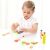 Girl playing with New Classic Toys wooden salad set
