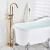 Blackswan M51.1 freestanding bathtub faucet in matte gold next to a bathtub