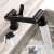 Blackswan M321 matte black bathroom sink faucet with pull-out spray head, showing water flow