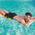 Bestway inflatable pool float, colorful design, man relaxing on it