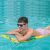 Man relaxing on a Bestway inflatable beach mattress in a pool