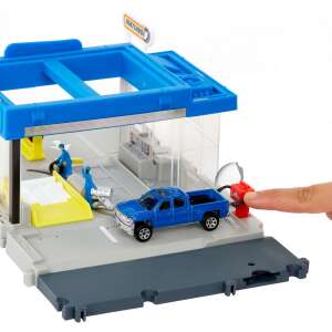 Matchbox Action Drivers Auto Shop playset with a blue Chevrolet Silverado 1300 toy car, showing the gas pump feature - Mattel