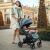 Woman pushing Petite & Mars Cross Stroller with baby in city