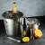 Kinghoff KH 1389 4-piece cocktail set, stainless steel, includes ice bucket, cocktail shaker, ice tongs, and jigger, with champagne bottle, ice, lemon and orange slices