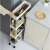 White 4-tier rolling storage cart with stainless steel frame, perfect for kitchen, bathroom, or laundry room organization