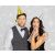 Couple celebrating with gold and silver party hats and blowouts