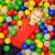 Child playing in a ball pit with colorful plastic balls