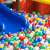 Springos plastic balls in a ball pit with a blue slide