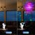 Before and after: Astronaut Star Projector Night Light projecting stars in a room