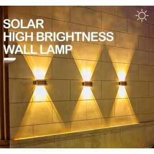 Solaris 6 LED solar powered wall light illuminating a wall - Garden