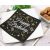 Happy Birthday napkin on a plate with cutlery and wine corks, party table setting