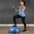 Woman exercising with Springos Bosu ball and resistance bands