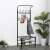 Black metal coat rack with shoe shelf, 18 hooks, 2 shelves, 187x67cm, in a hallway