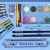 Close-up of Disney Stitch art supplies: watercolors, pencils, eraser, and ruler