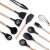 Black silicone kitchen tools with wooden handles